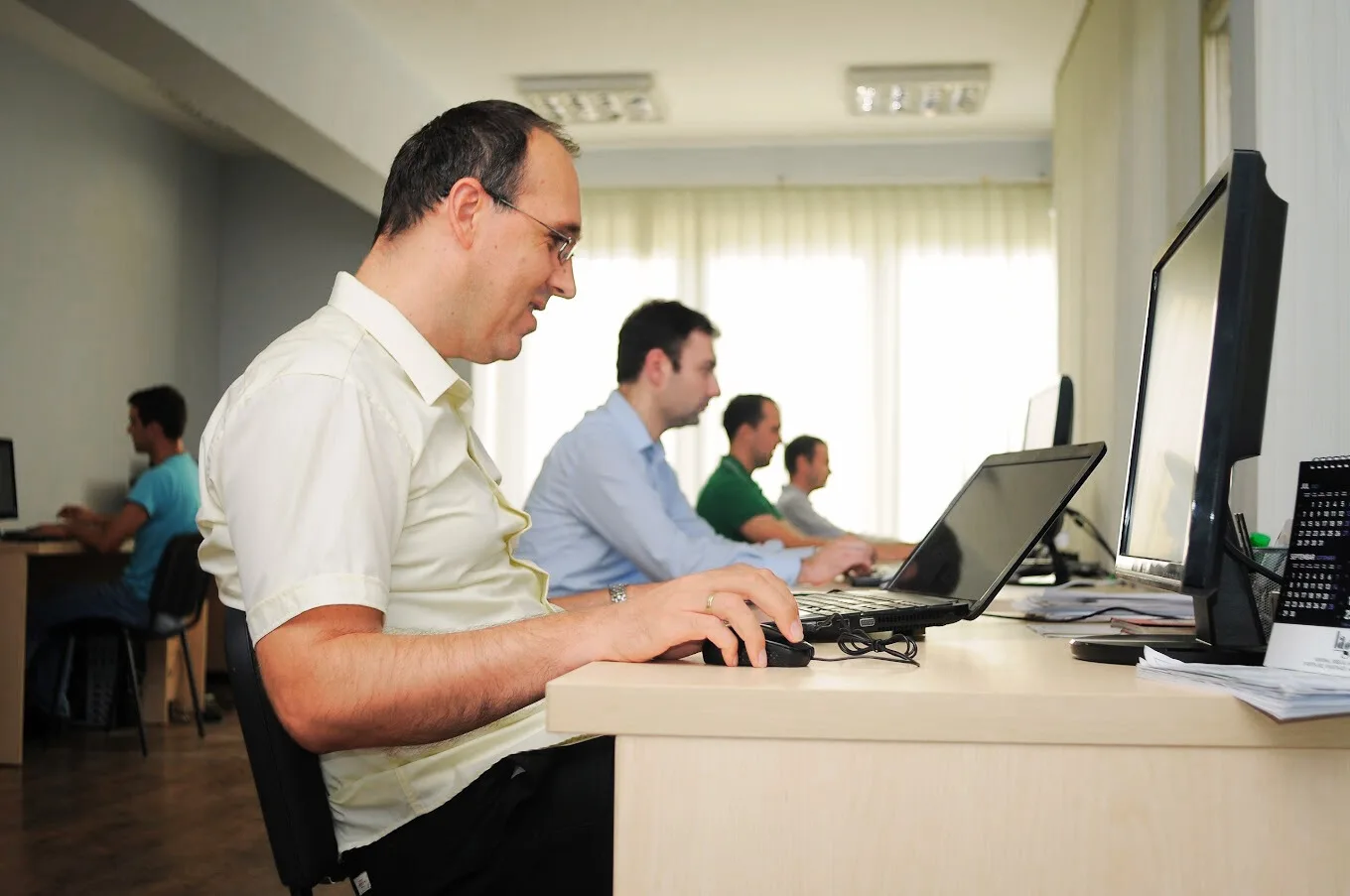 Mihajlovic Soft Programmer sitting at office desk at computer